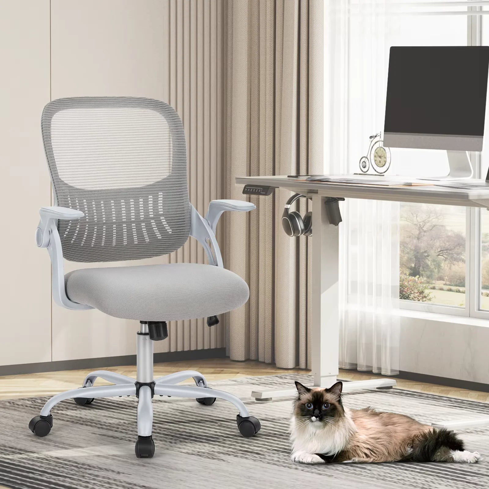 JHK C-3718 ergonomic mesh office chair in light gray beside a desk, with a cat nearby